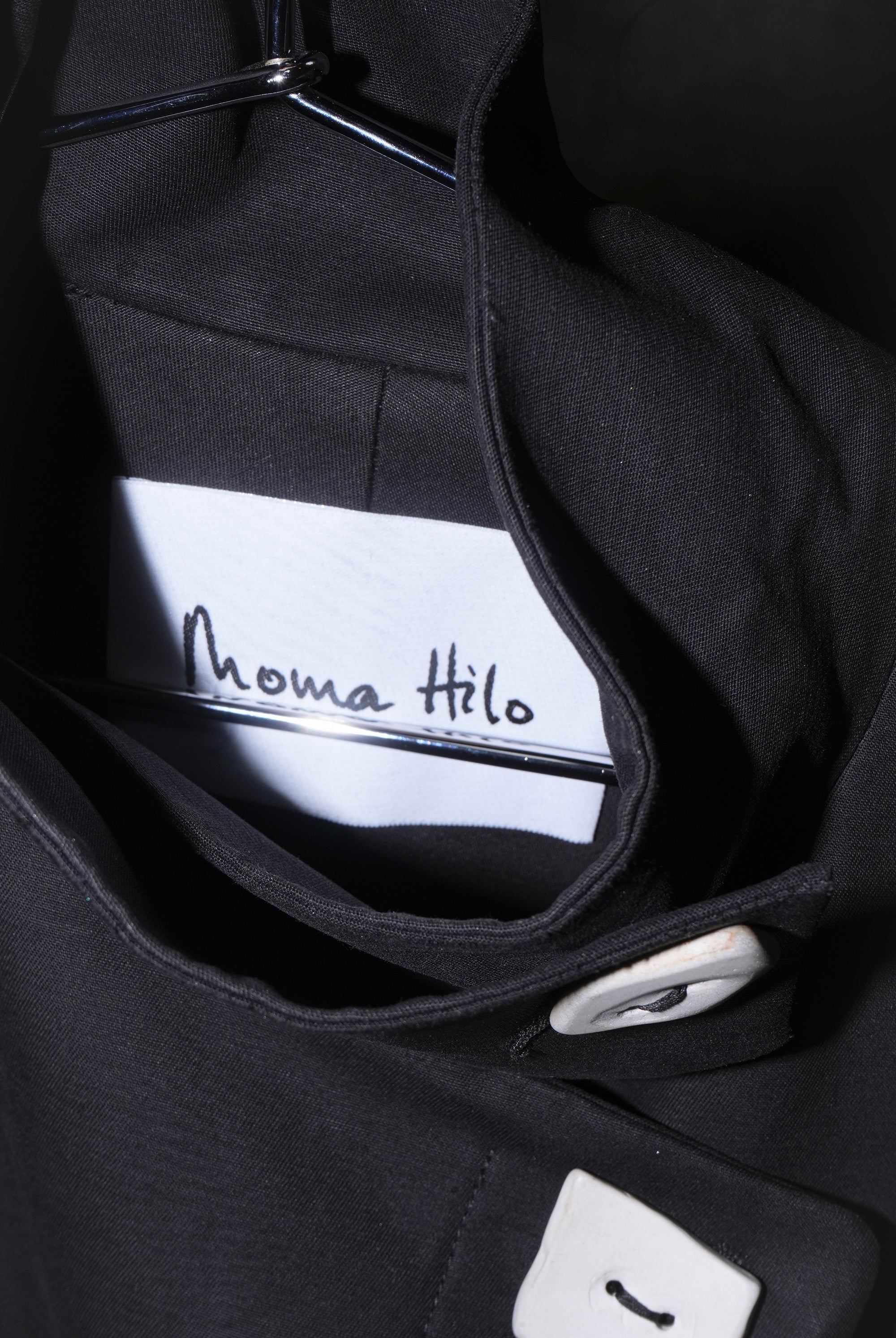 BRANDING CLOSE UP OF HILDA COAT IN BLACK