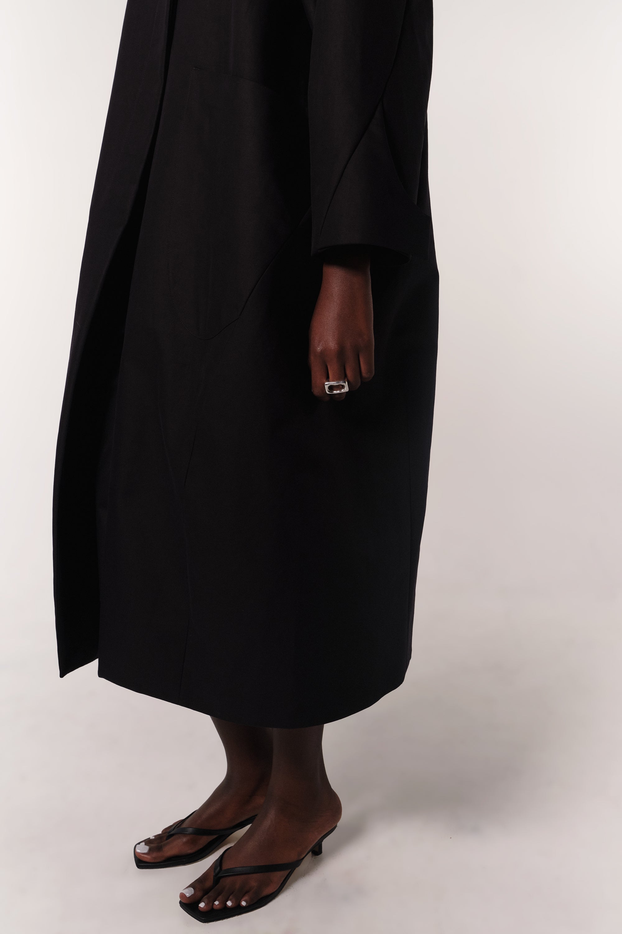 LOWER SECTION OF BLACK HILDA COAT ON MODEL