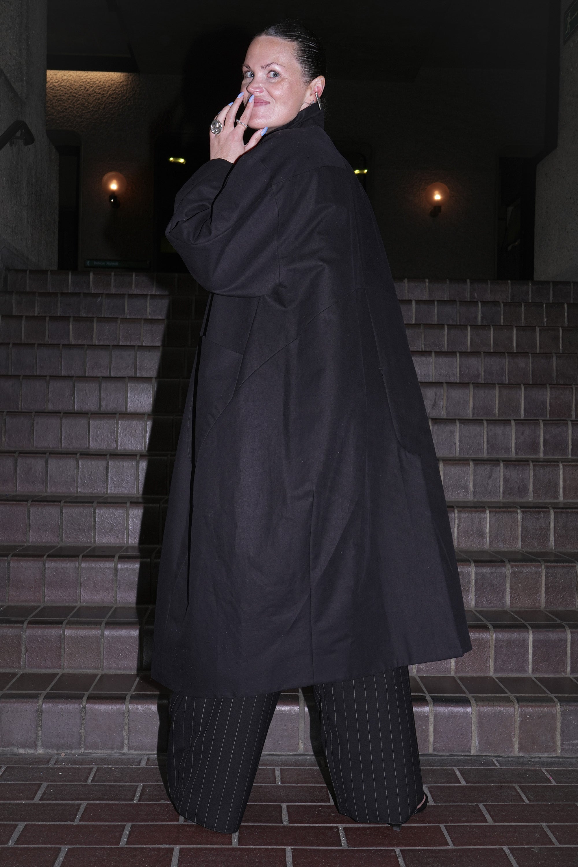 BLACK COTTON HILDA COAT FROM BACK SHOWING SEAM DETAILS