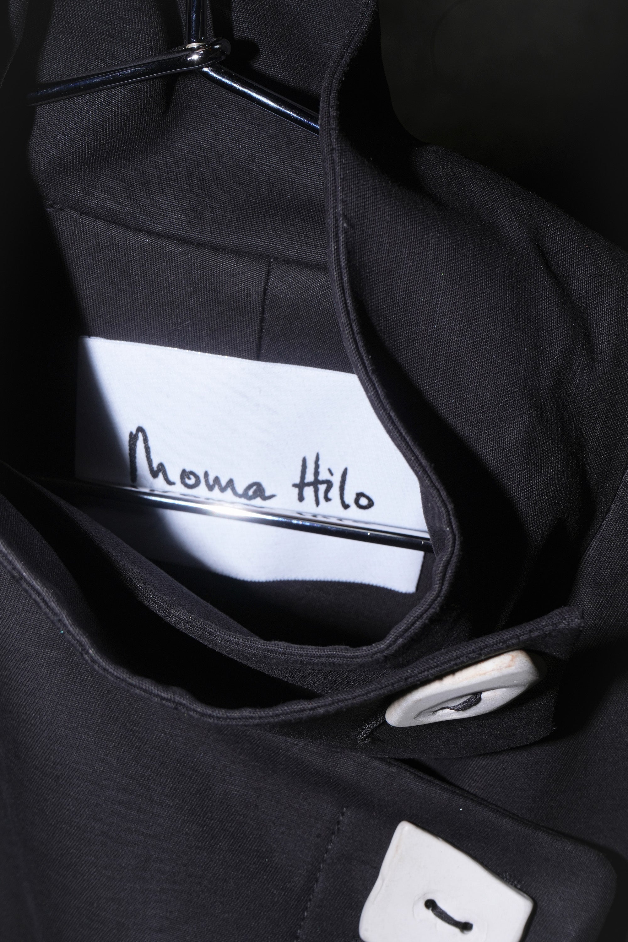 BRANDING CLOSE UP OF HILDA COAT IN BLACK