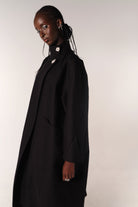 MODEL WEARING BLACK HILDA COAT IN DEADSTOCK COTTON FABRIC