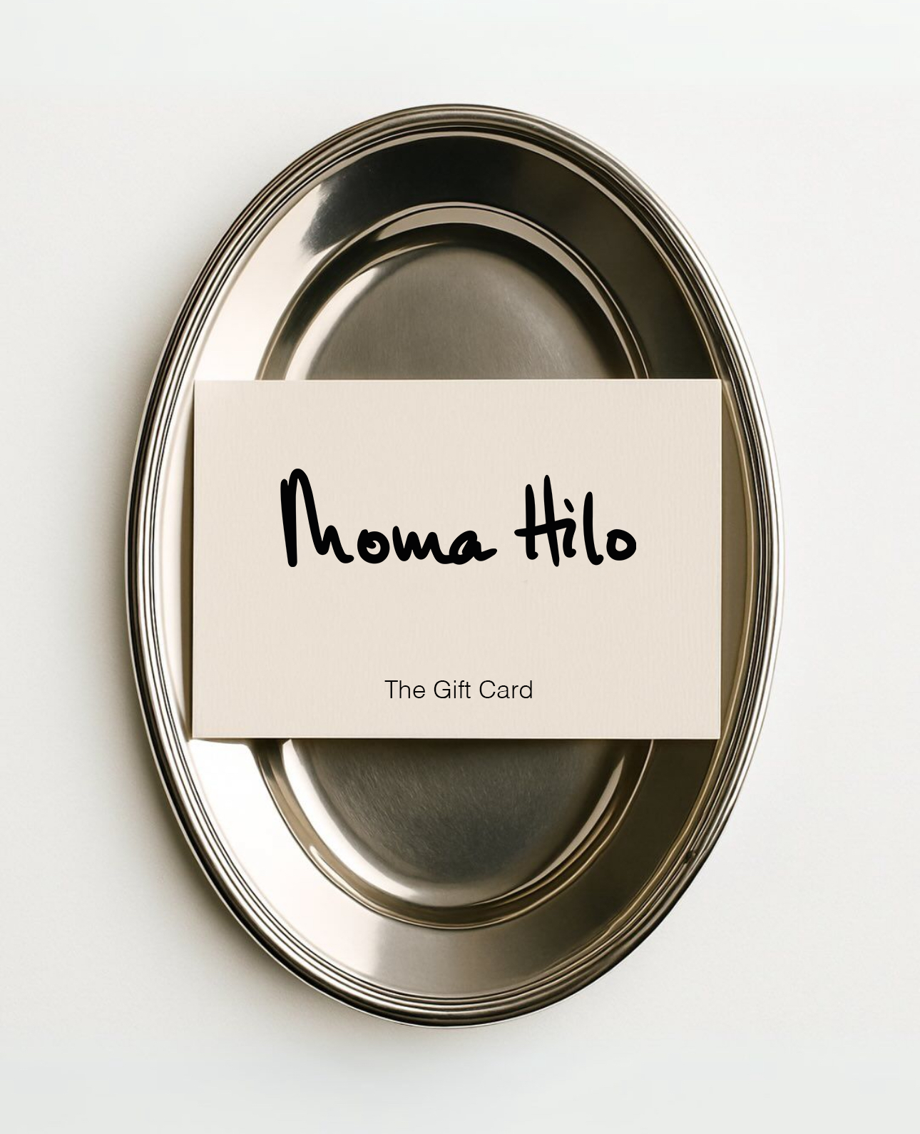 Metallic tray with a 'Moma Hilo' gift card on a white background