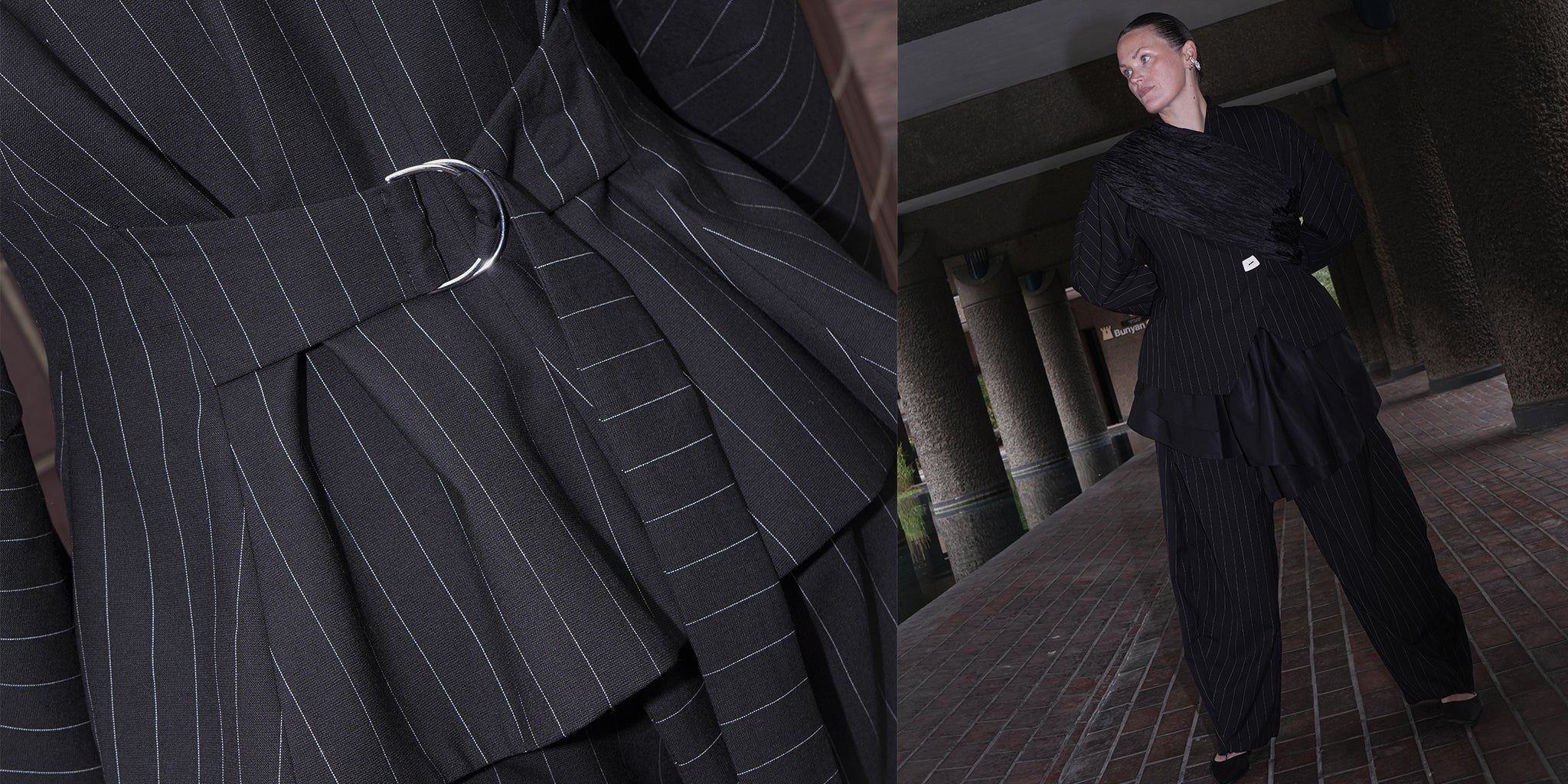 Black pinstripe blazer with a belt and a person wearing a black outfit in an urban setting.