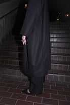 SIDE VIEW OF HILDA COAT IN BLACK DEADSTOCK COTTON